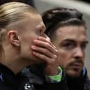 Manchester City's Erling Haaland (L) and Jack Grealish sit on the bench during the English FA Cup fifth round football match between Bristol City and Manchester City  on February 28, 2023.  (Photo by Adrian DENNIS / AFP)