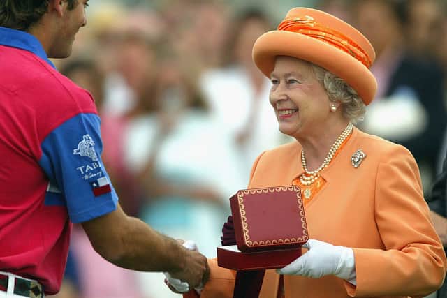 WINDSOR, ENGLAND - JULY 25:  Queen Elizabeth II gives a prize to Jose Donoso at the Guards Polo Club on July 25, 2004 in Windsor, England. (Photo by Carl De Souza/Getty Images)