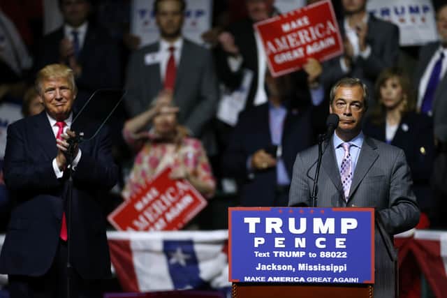 Republican Presidential nominee Donald Trump, left, listens to United Kingdom Independence Party leader Nigel Farage speak during a campaign rally at the Mississippi Coliseum on August 24, 2016 in Jackson, Mississippi. Thousands attended to listen to Trump's address in the traditionally conservative state of Mississippi. (Photo by Jonathan Bachman/Getty Images)