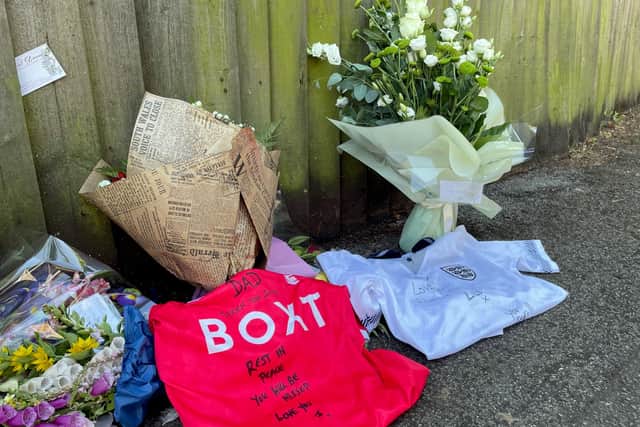 Football shirts beside floral tributes by his sons Lee and James, at the scene on Magdala Road, Nottingham, where 65-school caretaker Ian Coates was stabbed to death (Photo: Matthew Cooper/PA Wire)