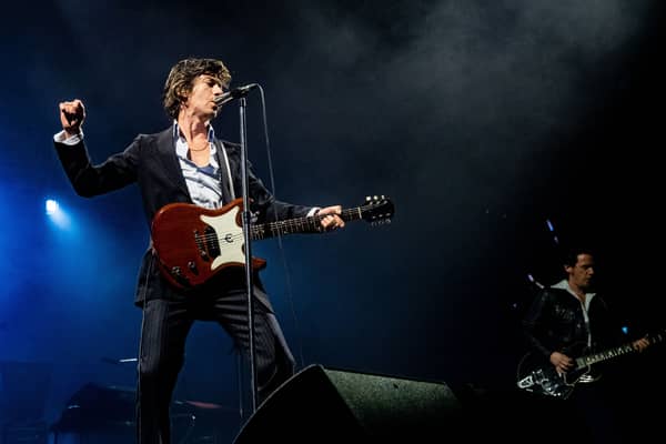 Alex Turner (L) of the Arctic Monkeys performs during a concert. PAUL BERGEN/ANP/AFP via Getty Images