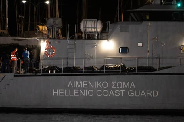 Bags with bodies are pictured in a coast guard vessel before at the port in Kalamata, Greece on June 14, 2023, after a boat sank. (Photo by ANGELOS TZORTZINIS/AFP via Getty Images)