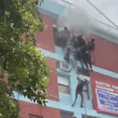 Students climb down rope to escape burning building. Picture: SWNS