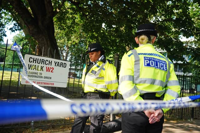 Police officers at the scene on Church Yard Walk near to Paddington Green in London, after a boy was stabbed to death (Photo: James Manning/PA Wire)