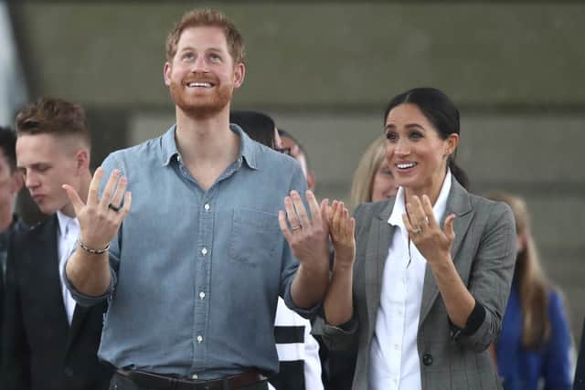 Prince Harry, Duke of Sussex and Meghan, Duchess of Sussex react as they look out towards the heavy rain and storm as they visit the Clontarf Foundation and Girls Academy at Dubbo College on October 17, 2018 in Dubbo, Australia. (Photo by Cameron Spencer/Getty Images)