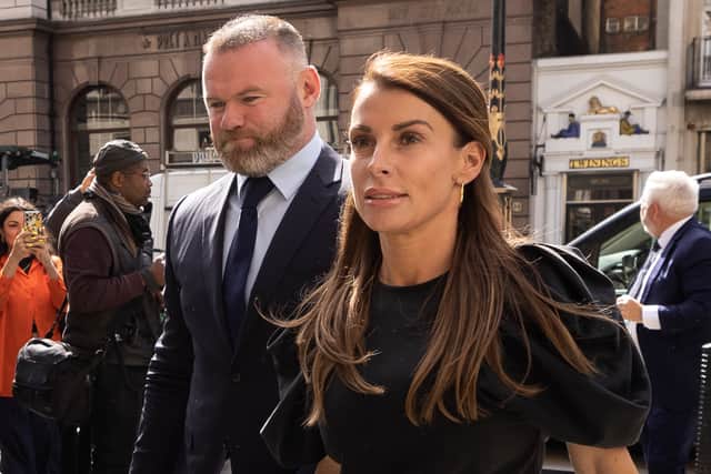LONDON, ENGLAND - MAY 12: Coleen Rooney arrives with husband Wayne Rooney at Royal Courts of Justice, Strand on May 12, 2022 in London, England. Coleen Rooney, wife of Derby County manager and former England football player Wayne Rooney, and Rebekah Vardy, wife of Leicester City striker Jamie Vardy, are locked in a libel battle dubbed by the media as the "Wagatha Christie" trial. The case centres around accusations that Mrs. Vardy leaked false stories about Mrs. Rooney's private life to the press. (Photo by Dan Kitwood/Getty Images)