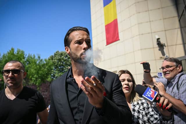Tristan Tate, brother of the controversial influencer Andrew Tate, arrives at the Municipal Court of Bucharest (Photo by DANIEL MIHAILESCU/AFP via Getty Images)