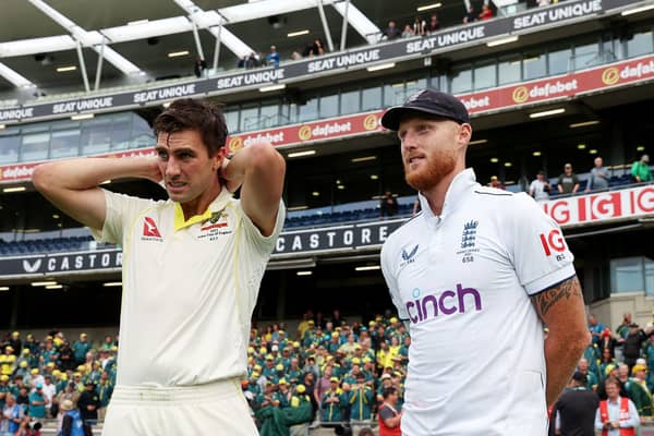 A defeated Ben Stokes stands next to Australia’s captain and match-winner Pat Cummins
