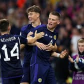 Scott McTominay celebrates with Scotland teammates after scoring their second goal against Georgia