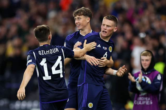 Scott McTominay celebrates with Scotland teammates after scoring their second goal against Georgia