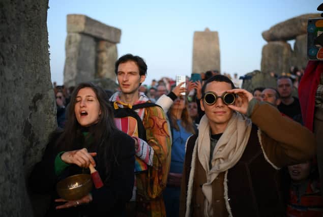 Revellers celebrate the Summer Solstice as the sun rises at Stonehenge on 21 June 2023 (Photo: DANIEL LEAL/AFP via Getty Images)