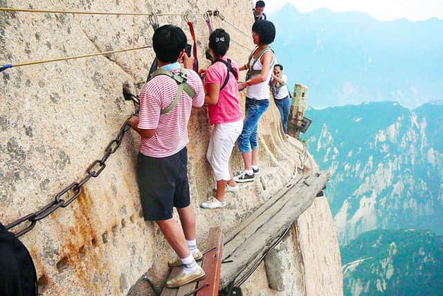 The perilous face of Mt Huashan, accessible only by planks nailed up on the cliff faces of the mountain (Credit: China Discovery)