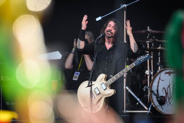 Dave Grohl of the Foo Fighters gestures to the sky after referring to the late drummer Taylor Hawkins as the band perform on the Pyramid Stage on Day 3 of Glastonbury Festival 2023 on June 23, 2023 in Glastonbury, England. (Photo by Leon Neal/Getty Images)