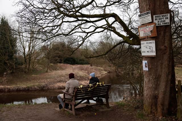 People sit on the bench which has some yellow ribbons adorning it, at the place where the phone of missing woman Nicola Bulley was found, next to the River Wyre in St Michael's on Wyre on February 20, 2023 in Preston, England. Yesterday Police recovered a body thought to be that of missing woman, Nicola Bulley, 45, who disappeared while walking her dog along the banks of the River Wyre on Saturday, Jan 27. (Photo by Jeff J Mitchell/Getty Images)(Photo by Jeff J Mitchell/Getty Images)