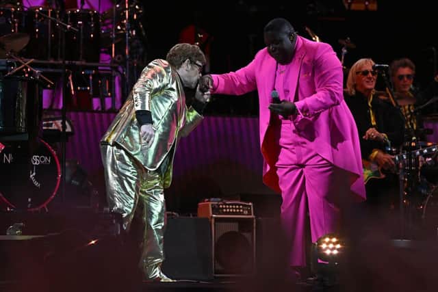 Sir Elton John kisses the hand of US singer Jacob Lusk (R) during a performance on the Pyramid Stage on day 5 of the Glastonbury festival in the village of Pilton in Somerset, southwest England, on June 25, 2023. (Photo by OLI SCARFF/AFP via Getty Images)
