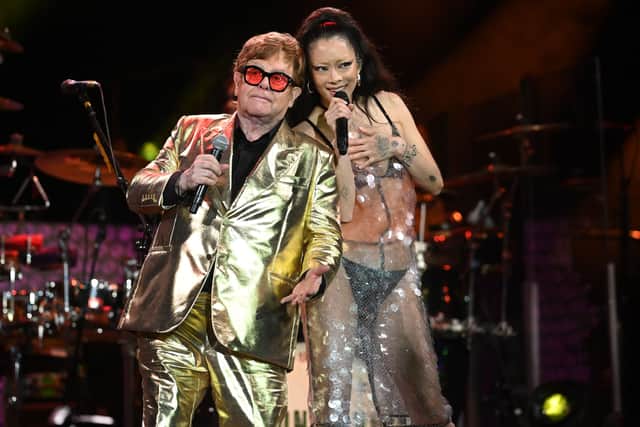 British legendary singer Elton John (L) performs with Rina Sawayama (R) on the Pyramid Stage on day 5 of the Glastonbury festival in the village of Pilton in Somerset, southwest England, on June 25, 2023. (Photo by OLI SCARFF/AFP via Getty Images)