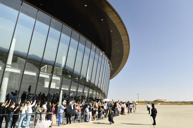 Spectators gather to watch the Virgin Galactic SpaceShipTwo space plane Unity take off at Spaceport America, near Truth and Consequences, New Mexico on July 11, 2021. (Photo by PATRICK T. FALLON/AFP via Getty Images)