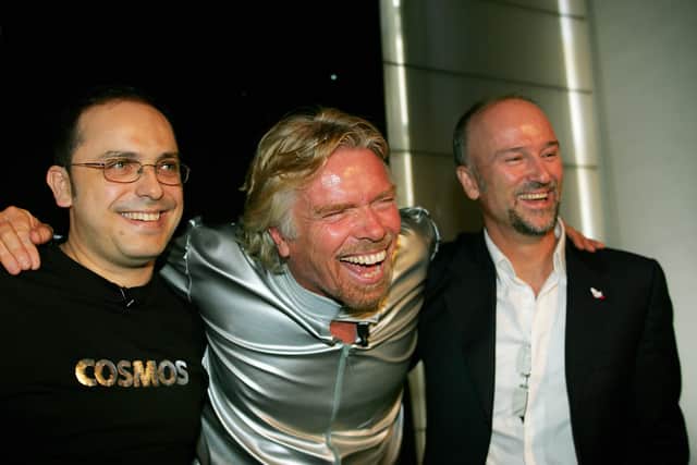 British tycoon Richard Branson (C) is joined by Wilson da Silva (L) and Brett Godfrey (R) for the announcement in Sydney, 13 December 2005, of Australia's first private astronauts to sign up for the Virgin Galactic flights into space.  (Credit: Greg Wood/AFP via Getty Images)