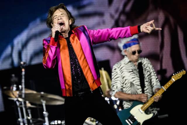 British rock band The Rolling Stones' British singer Mick Jagger (C) and British guitarist Keith Richards (R) perform on stage during a concert part of their European Tour in Decines-Charpieu's Stadium, near Lyon, on July 19, 2022. (Photo by JEFF PACHOUD / AFP) (Photo by JEFF PACHOUD/AFP via Getty Images)