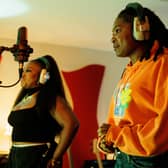 Ray BLK as Honey and Déja J. Bowens as Vita in Champion, recording music together (Credit: BBC/New Pictures Ltd/Ben Gregory-Ring) 