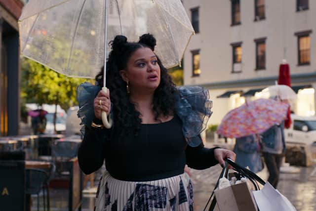 Michelle Buteau as Mavis in Survival of the Thickest, walking down the street in the rain with an umbrella (Credit: Netflix)