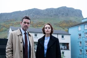Dougray Scott as DI Ray Lennox and Joanna Vanderham as DS Amanda Drummond in Crime, a mountain range in the distance behind them (Credit: ITV)