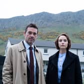 Dougray Scott as DI Ray Lennox and Joanna Vanderham as DS Amanda Drummond in Crime, a mountain range in the distance behind them (Credit: ITV)