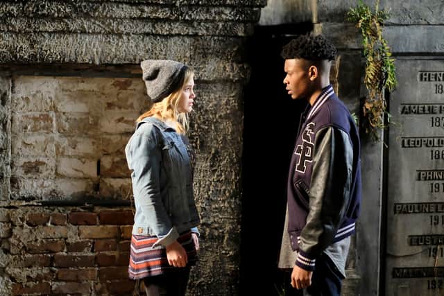 Olivia Holt as Tandy and Aubrey Joseph as Tyrone in Marvel's Cloak and Dagger, confronting each other in a graveyard (Credit: Marvel Studios/Freeform)