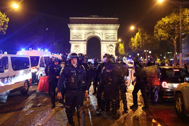 French police officers patrol in front of the Arc de Triomphe in the Champs Elysees area of Paris on July 1, 2023, five days after a 17-year-old man was killed by police in Nanterre, a western suburb of Paris. (Photo by CHARLY TRIBALLEAU/AFP via Getty Images)