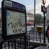 "Justice Nahel" is scrawled the Palais Royal Musee du Louvre metro sign on July 2, 2023 in Paris, France. Last night demonstrators took to the streets and clashed violently with police, in protest of the shooting and killing of a 17-year-old boy during a traffic stop by Parisian police officers.  According to the French government hundreds of protestors have been arrested in a fifth night of nationwide rioting as police deployed reinforcements to flashpoint cities. (Photo by Abdulmonam Eassa/Getty Images)