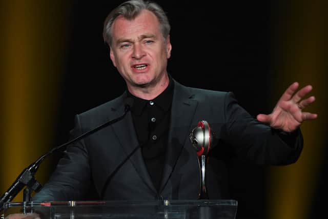 NATO (National Association of Theatre Owners) Spirit of the Industry Award co-recipient British director Christopher Nolan speaks on stage next to his wife producer Emma Thomas (0ff frame) during the Big Screen Achievement Awards at CinemaCon 2023 at Caesars Palace on April 27, 2023 in Las Vegas, Nevada. (Photo by VALERIE MACON / AFP) 