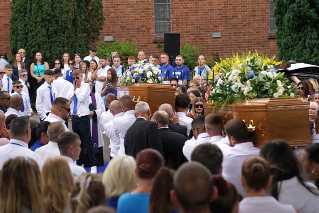 The coffins of Kyrees Sullivan and Harvey Evans are carried into the Church of the Resurrection in Ely, Cardiff. (Credit: Jacob King/PA Wire)