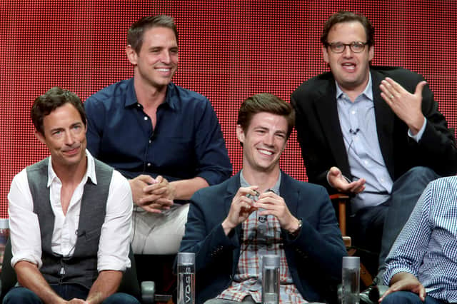 Producers Greg Berlanti and Andrew Kreisberg and actors Tom Cavanagh and Grant Gustin onstage during a panel for The Flash at the 2014 Summer Television Critics Association event (Credit: Frederick M. Brown/Getty Images)