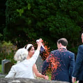George Osbourne and Thea Rogers covered in orange confetti. Picture: SWNS