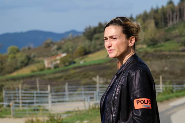 Julie Gayet as Gabrielle Perez in Disturbing Disappearances, wearing a leather jacket and an orange police armband (Credit: Robin Nicolas/FTV/Walter Presents) 