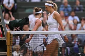 Belarus' Victoria Azarenka (R) passes by Ukraine's Elina Svitolina during their women's singles tennis match on the seventh day of the 2023 Wimbledon Championships at The All England Tennis Club in Wimbledon, southwest London, on July 9, 2023. (Photo by Glyn KIRK / AFP) / RESTRICTED TO EDITORIAL USE (Photo by GLYN KIRK/AFP via Getty Images)