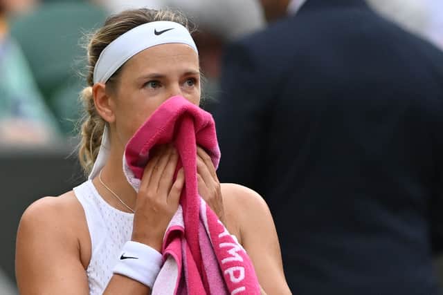 Belarus' Victoria Azarenka uses a towel during a break in play against Ukraine's Elina Svitolina during their women's singles tennis match on the seventh day of the 2023 Wimbledon Championships at The All England Tennis Club in Wimbledon, southwest London, on July 9, 2023. (Photo by Glyn KIRK / AFP)