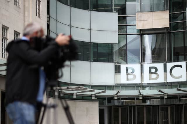 A member of the media outside BBC Broadcasting House in central London 9 July (Photo: HENRY NICHOLLS/AFP via Getty Images)