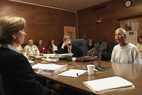 CORONA, CA - JUNE 28:  Sheron Lawin (L), a member of the Board of Prison Terms commissioners, listens to Leslie Van Houten (R), after her parole was denied 28 June 2002 at the California Institution for Women in Corona, California. Van Houten, 53, has served over 30 years in prison for her involvement in the Tate-LaBianca killings.  Van Houten's attorney Christie Webb is at center.  (Photo credit should read DAMIAN DOVARGANES/AFP via Getty Images)