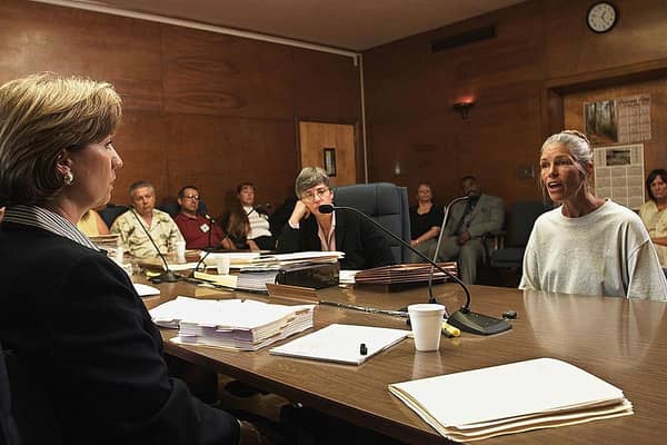 CORONA, CA - JUNE 28:  Sheron Lawin (L), a member of the Board of Prison Terms commissioners, listens to Leslie Van Houten (R), after her parole was denied 28 June 2002 at the California Institution for Women in Corona, California. Van Houten, 53, has served over 30 years in prison for her involvement in the Tate-LaBianca killings.  Van Houten's attorney Christie Webb is at center.  (Photo credit should read DAMIAN DOVARGANES/AFP via Getty Images)