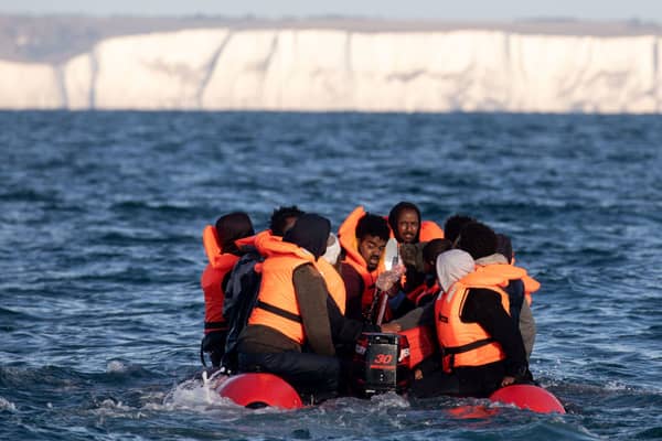 Migrants packed tightly onto a small inflatable boat attempt to cross the English Channel near the Dover Strait, the world’s busiest shipping lane, on September 07, 2020 off the coast of Dover, England. Credit: Luke Dray/Getty Images