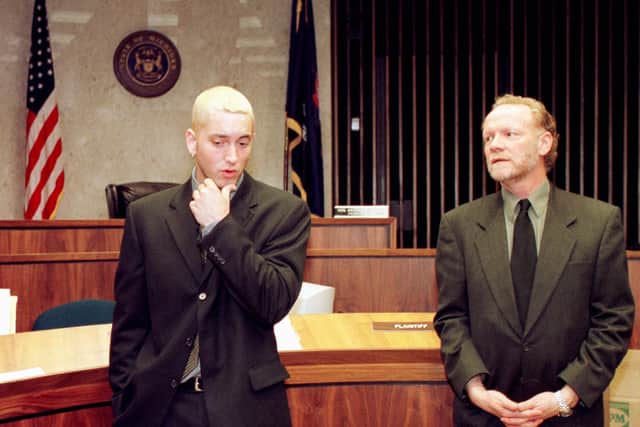  Eminem (Marshall Mathers) stands before the press alongside his lawyer in Macomb County Court following his sentencing on concealed weapons charges April 10, 2001 in Michigan. Mathers was given two years probation. (Photo by Bill Pugliano/Newsmakers)