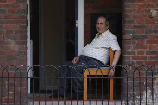 An elderly man sits outside in Hackney during the July 2022 heatwave (Photo by Hollie Adams/Getty Images)
