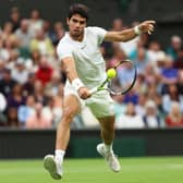 LONDON, ENGLAND - JULY 14: Carlos Alcaraz of Spain plays a backhand volley against Daniil Medvedev in the Men's Singles Semi Finals on day twelve of The Championships Wimbledon 2023 at All England Lawn Tennis and Croquet Club on July 14, 2023 in London, England.  (Photo by Clive Brunskill/Getty Images)