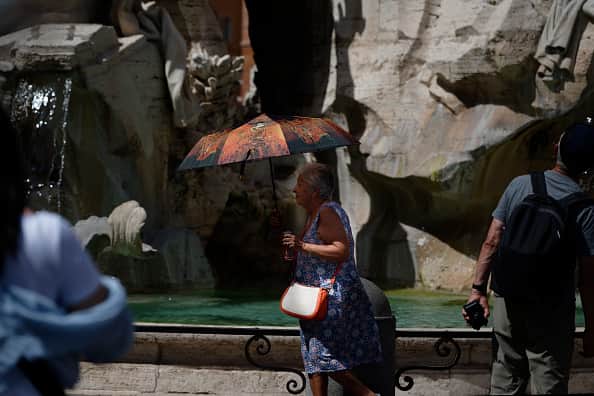 People cool off during an ongoing heat wave with temperatures reaching 40 degrees, at Piazza Navona, on July 16, 2023 in Rome, Italy.  (Photo by Massimo Valicchia/NurPhoto via Getty Images)