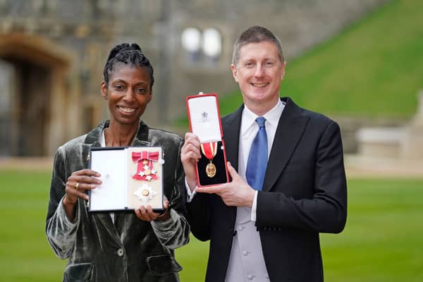 WINDSOR, UNITED KINGDOM - NOVEMBER 30:  Sharon White poses with her award after she was made a Dame CBE, for public service, next to her husband Sir Robert Chote posing with his award after he was made a Knight Bachelor, for services to fiscal policy and to the economy, at an investiture ceremony at Windsor Castle on November 30, 2021 in Windsor, England.  (Photo by Andrew Matthews - WPA Pool/Getty Images)