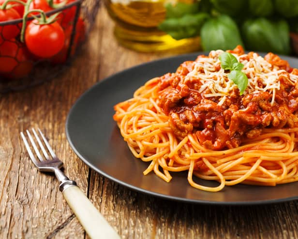 Spaghetti served on a black plate (Credit: Adobe)