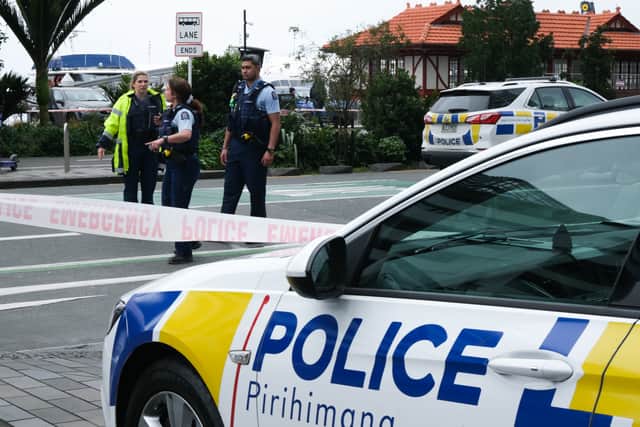Police officers stand on patrol in a cordoned downtown area on July 20, 2023 in Auckland, New Zealand. A gunman and two others were killed following a shooting in Auckland as the city prepares for the opening match of the women's football world cup. (Photo by Lynn Grieveson /Getty Images)