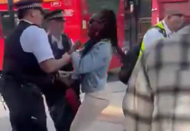 Screenshot of video showing Met Police officers arresting a mother in front of her crying son. Credit: @Saskia_Cole on Twitter