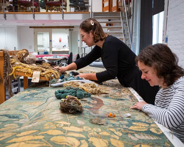 Conservators Elaine Owers and Yoko Hanegreefs carry out conservation stitch treatment on the final Gideon tapestry